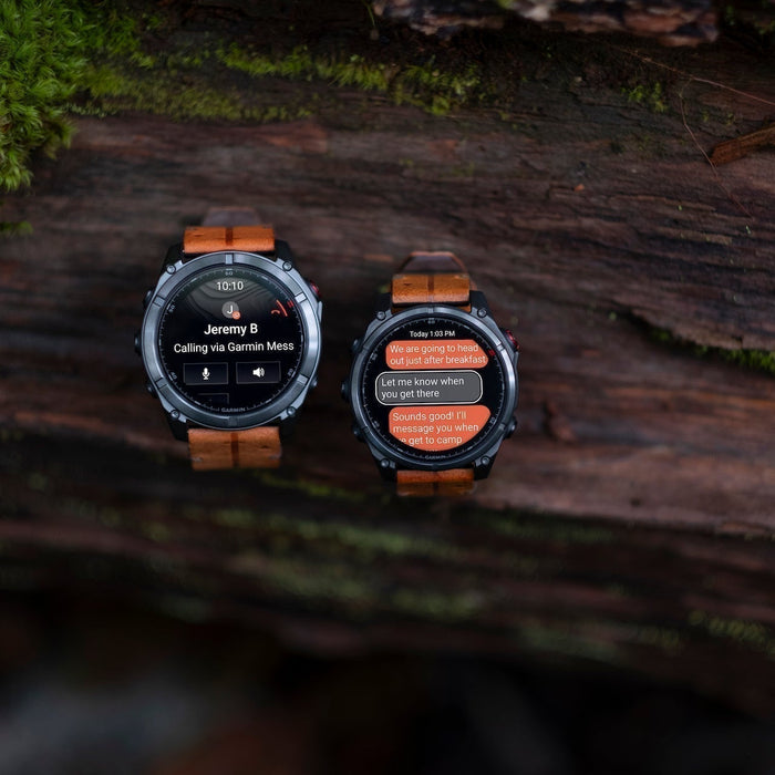 Both sizes of the Garmin fenix 8 Pro multisport watches on a log outdoors with messaging on the display