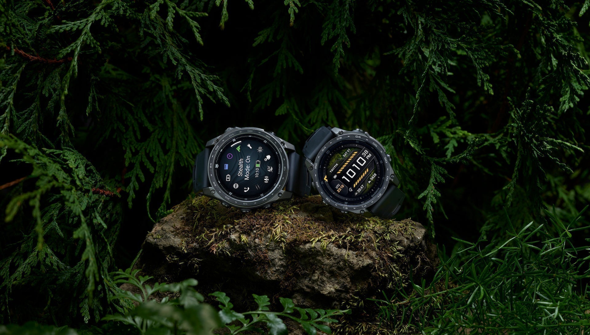 The AMOLED and Solar Garmin taxtix 8 tactical watches on a rock in a forest