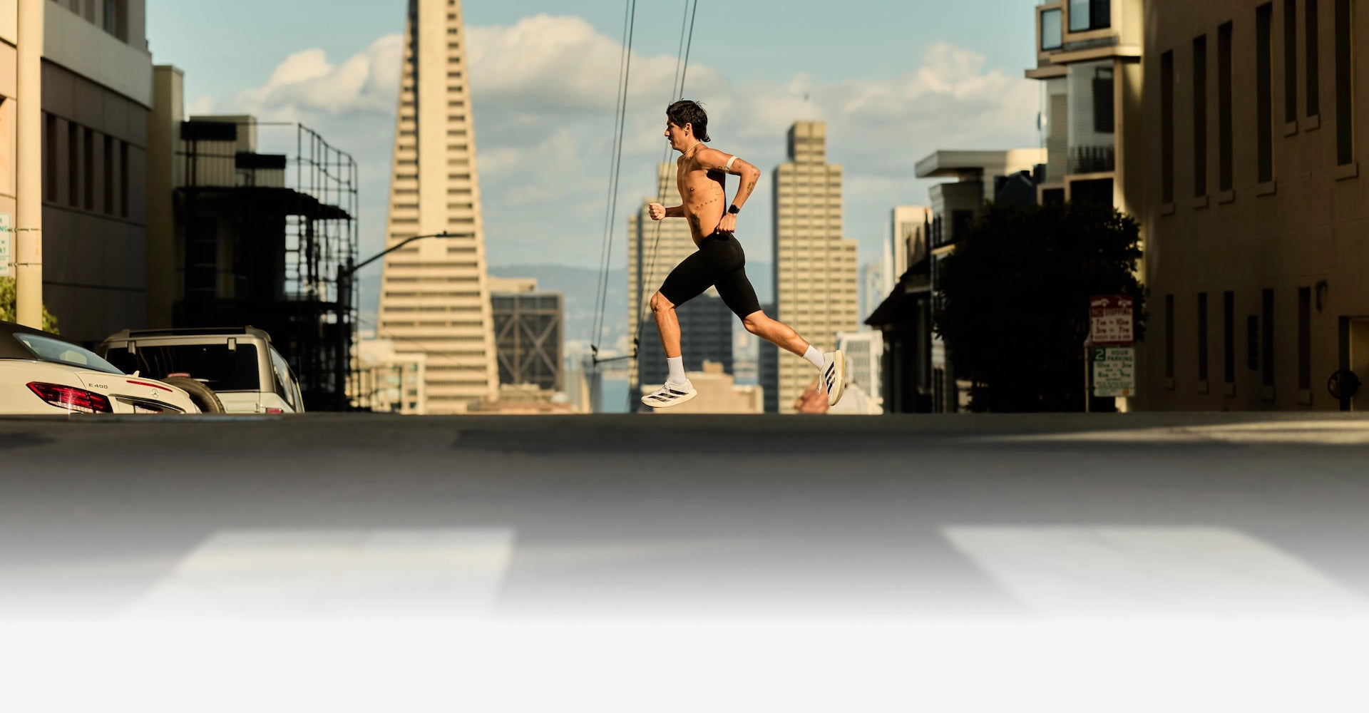 A running crossing a city street with the Coros Pace 4