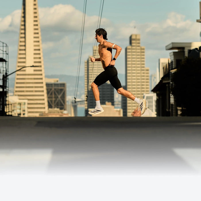 A running crossing a city street with the Coros Pace 4