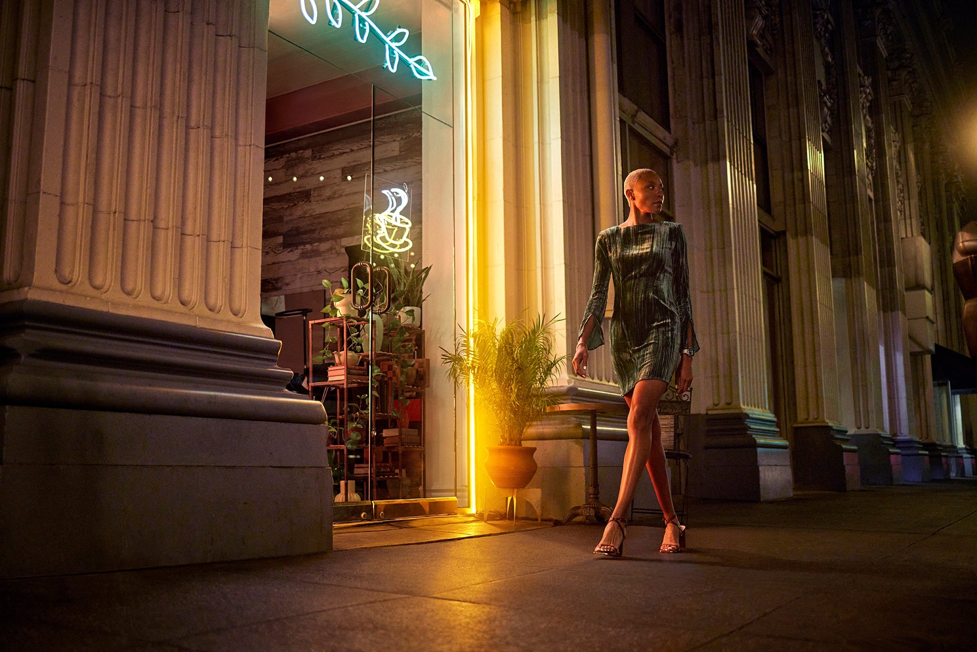 A woman outside a coffee shop dressed in evening wear and wearing a 42 mm Garmin epix Pro (Gen)