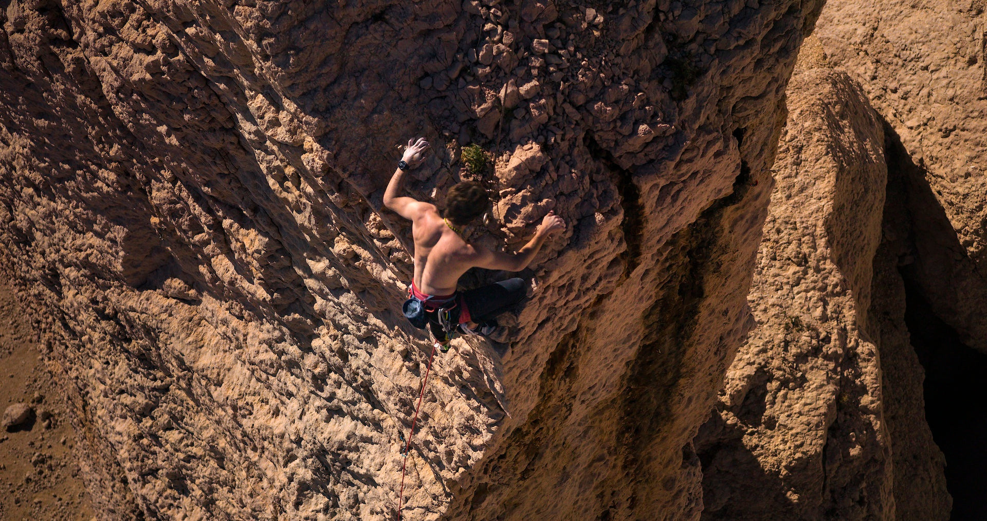 A man rock climbing with a Garmin fenix 8 multisport watch on his wrist