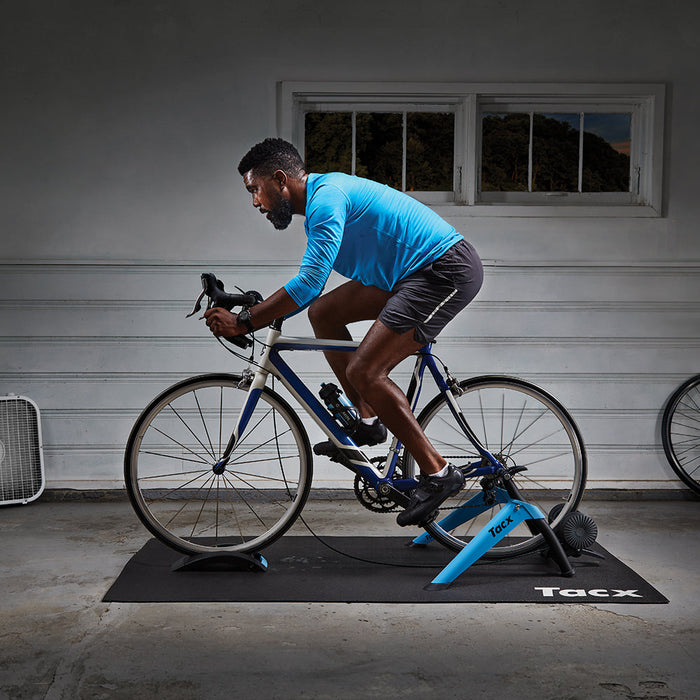 Triathlete using the Tacx Booster Indoor Trainer at the garage