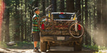 A man easily anchoring his bike securely in the truck using the Dakine Pickup Pad